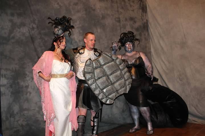 three people standing next to each other in costumes