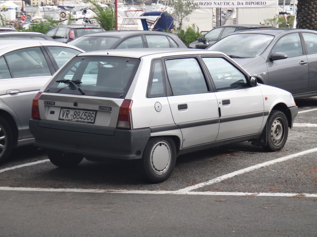 a car parked in the middle of some parking spaces