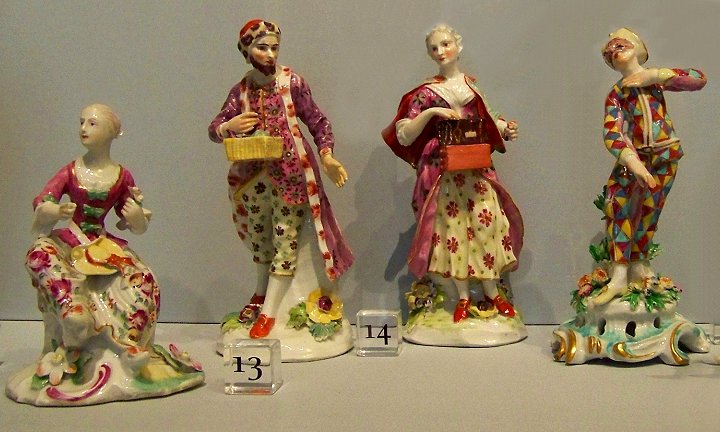 a group of statues of women, some wearing gowns