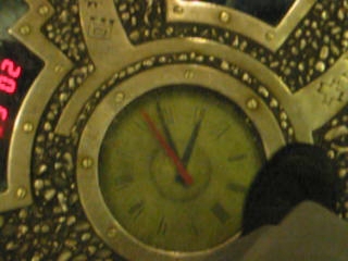 a large metal clock on a mosaic surface