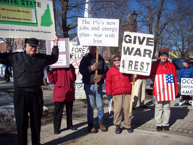 people holding signs at an occupyors rally
