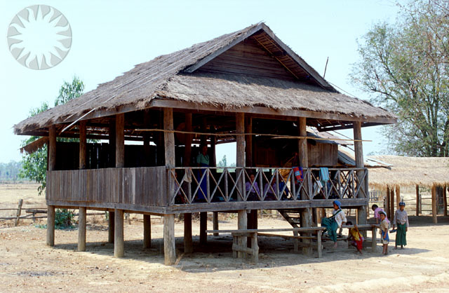 a wooden structure sitting on top of a dry grass field