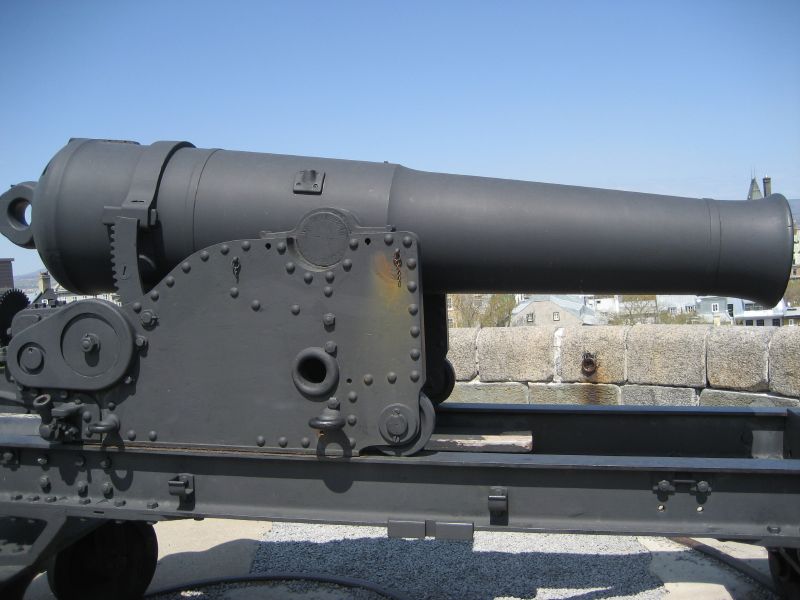a close up view of a cannon mounted on a rail