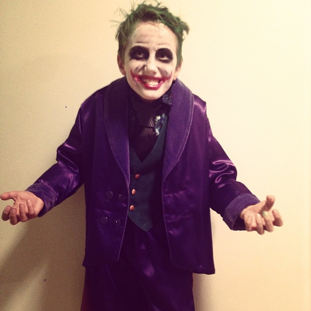 a person with a suit and joker makeup