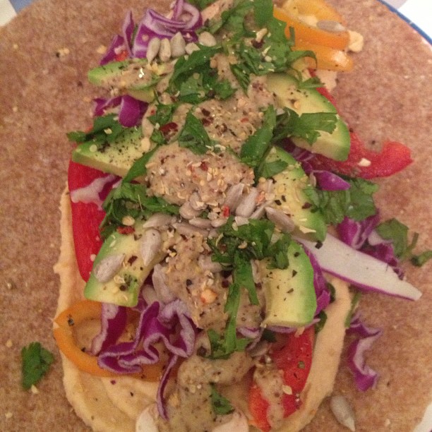 food sitting on top of a tortilla on a plate