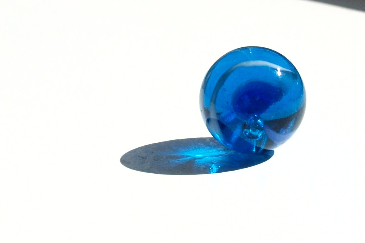the ring is made of glass and has a blue marble