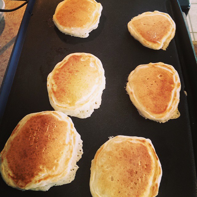 seven pancakes are on a cookie sheet ready to be baked