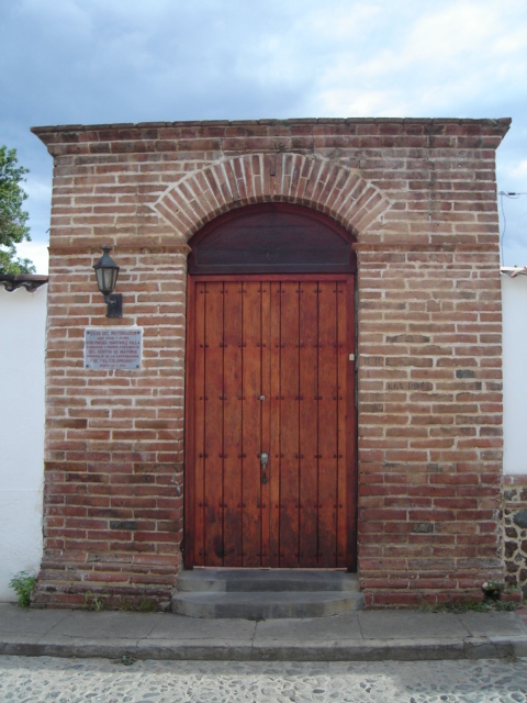 the entrance to a brick building with a wooden door