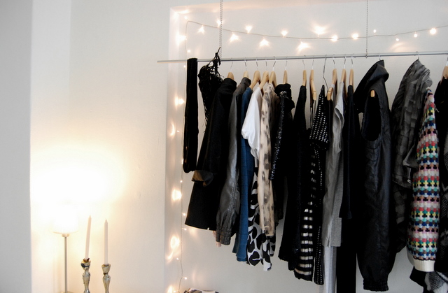 a room with some clothes hanging up against the wall