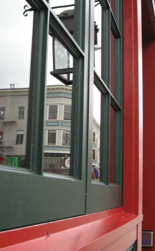 a window in a building with green frames