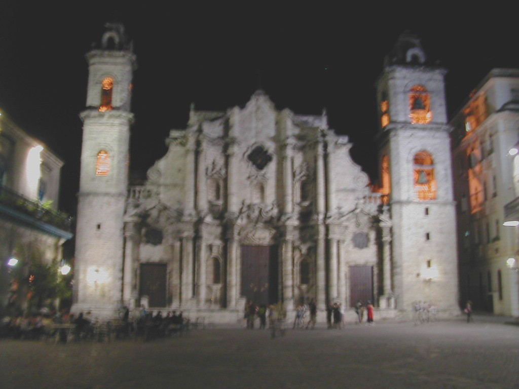 a large church with lots of tall buildings around it