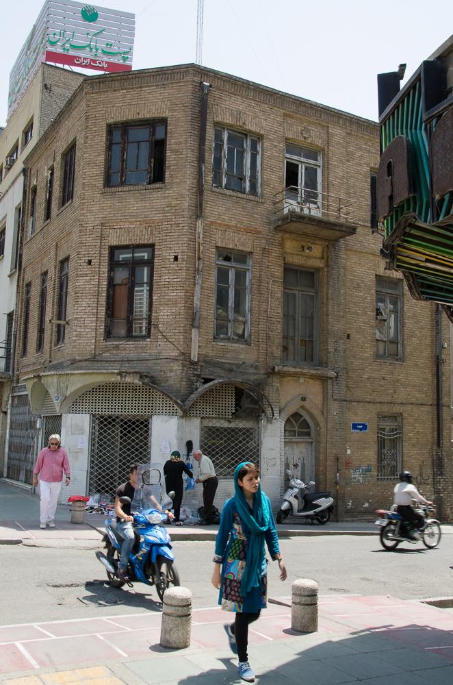 women walking through the streets in front of an old building