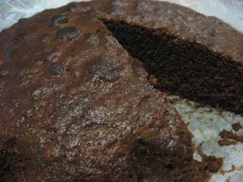 a chocolate cake with one slice cut out of it