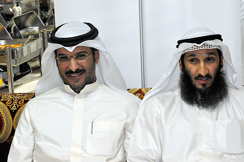two men in white are posed for the camera