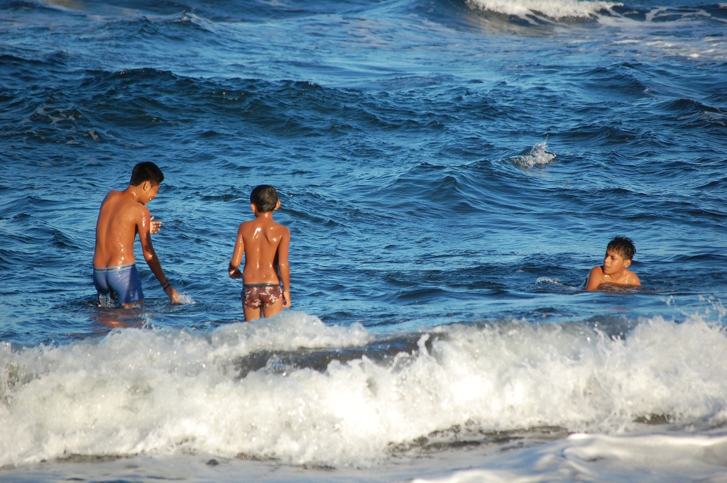 several people are wading in the ocean water