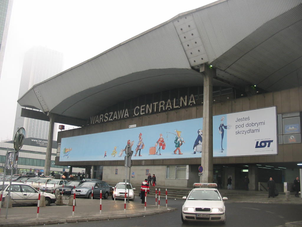 a large building with large cars parked in front