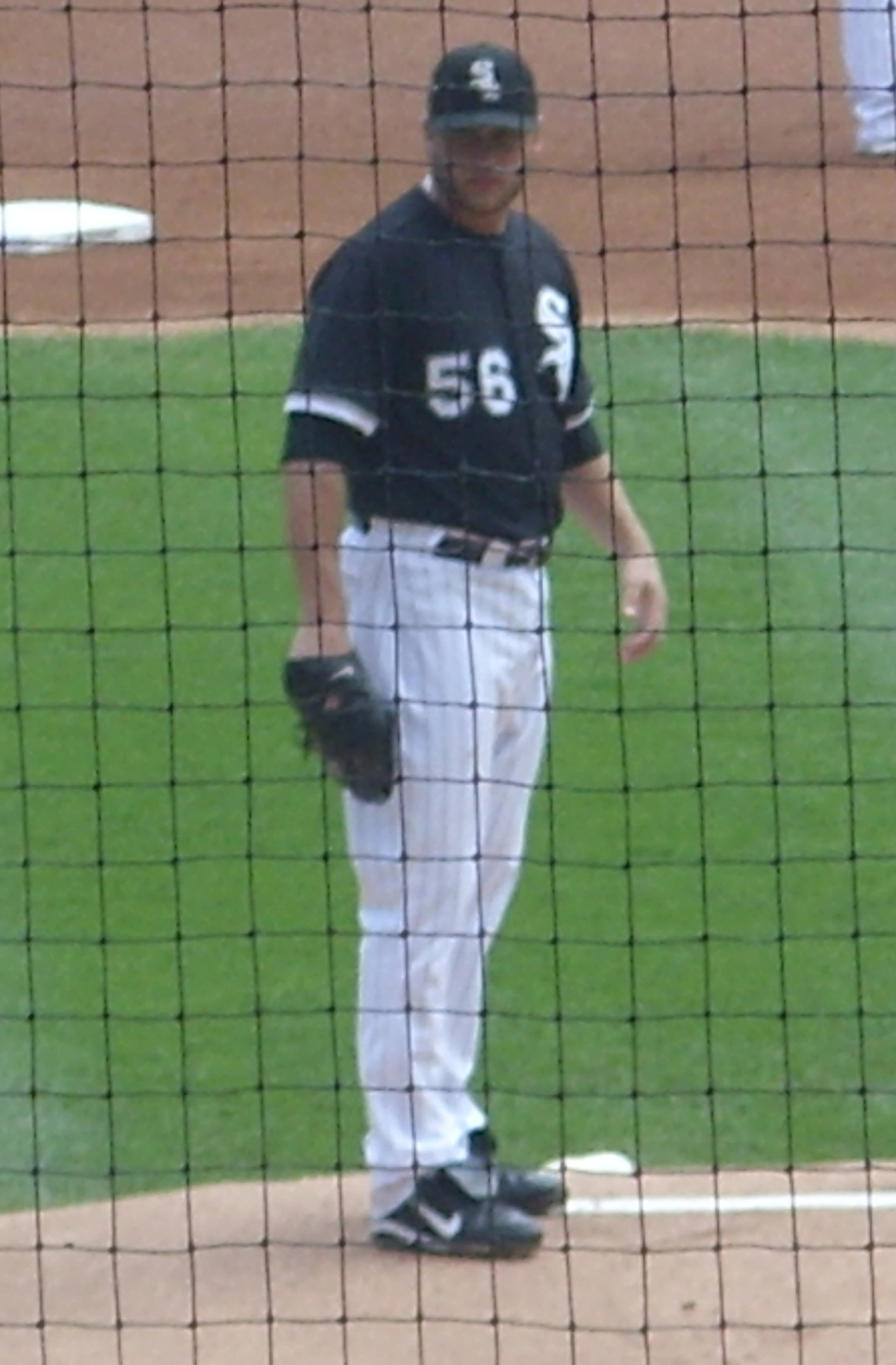 a baseball player standing on the mound during a game