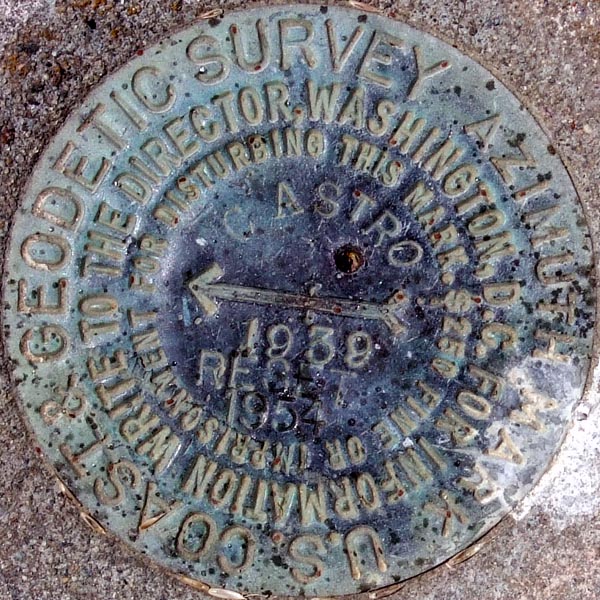 a manhole cover with words and arrows and the word survey