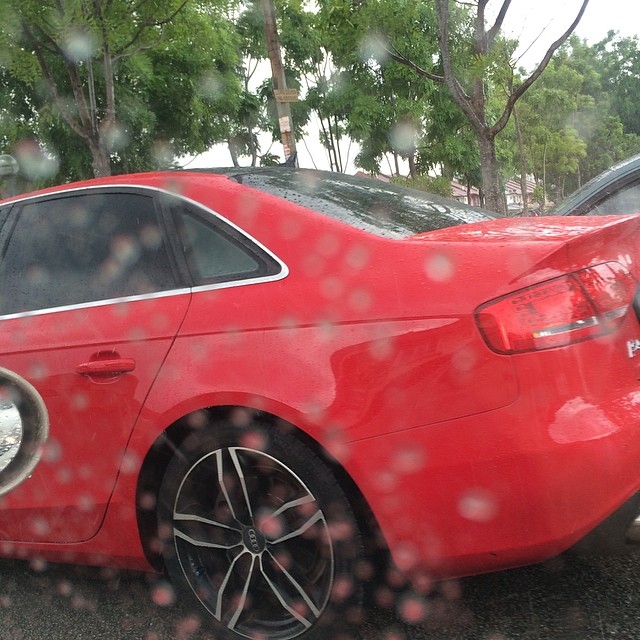 some cars parked on the street in the rain