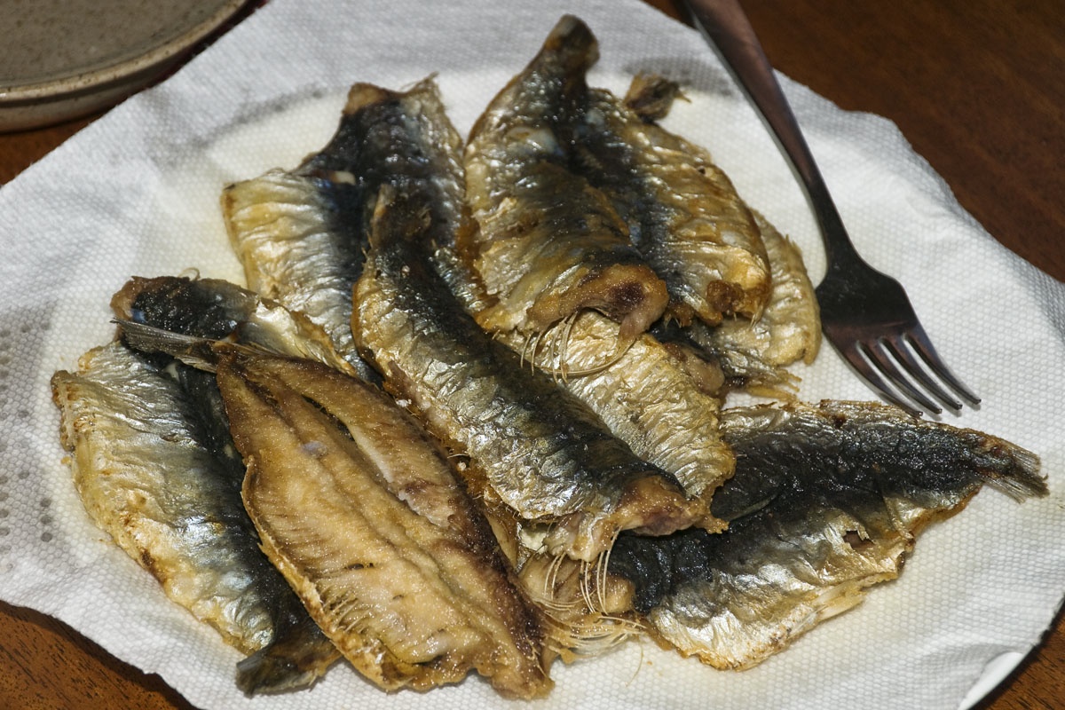 a plate full of fried fish and a fork