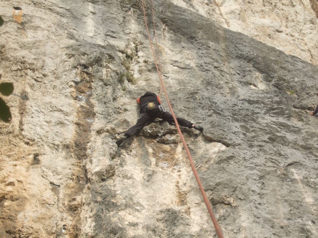 a man is climbing up a mountain and rope