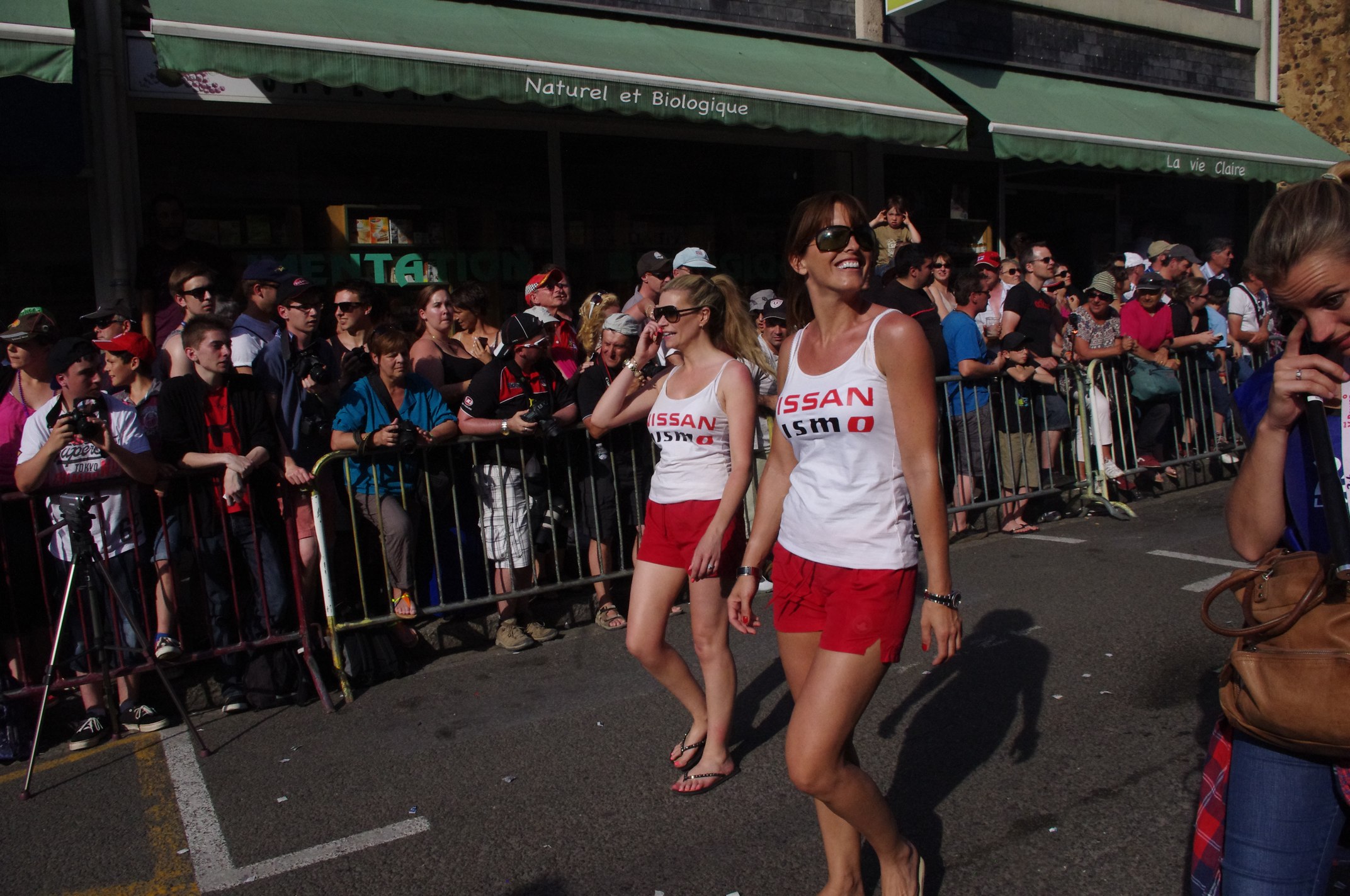 there are many people watching a parade on the street