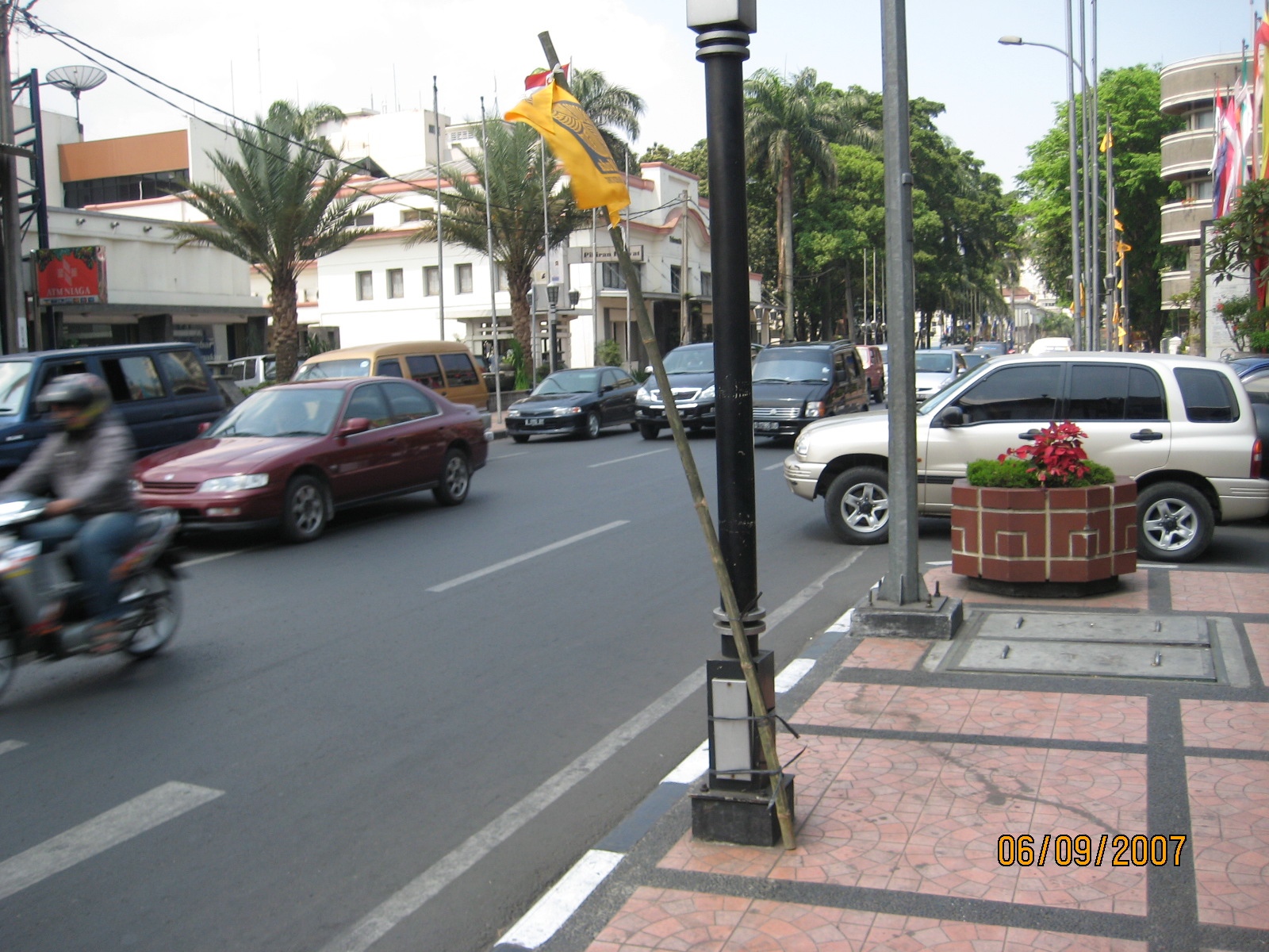 there are cars and motorcycles traveling down this street