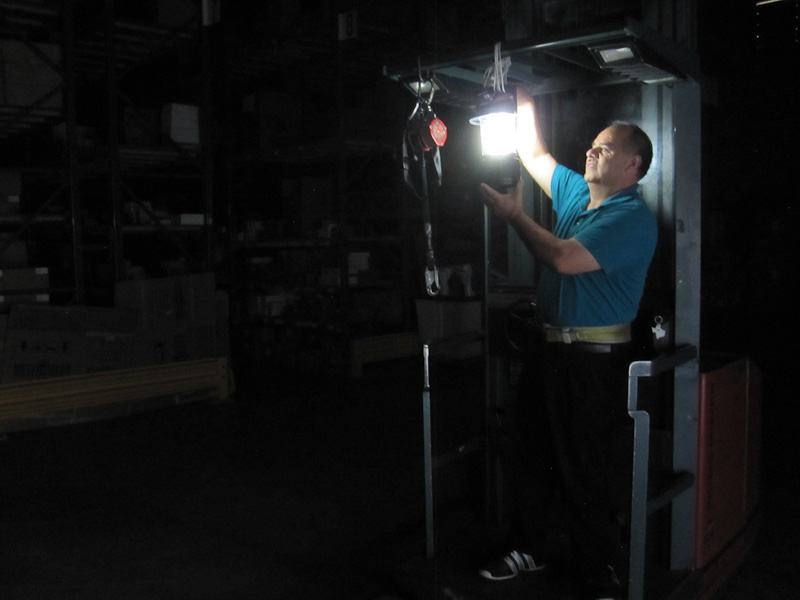 a man is holding a lite up light in the dark