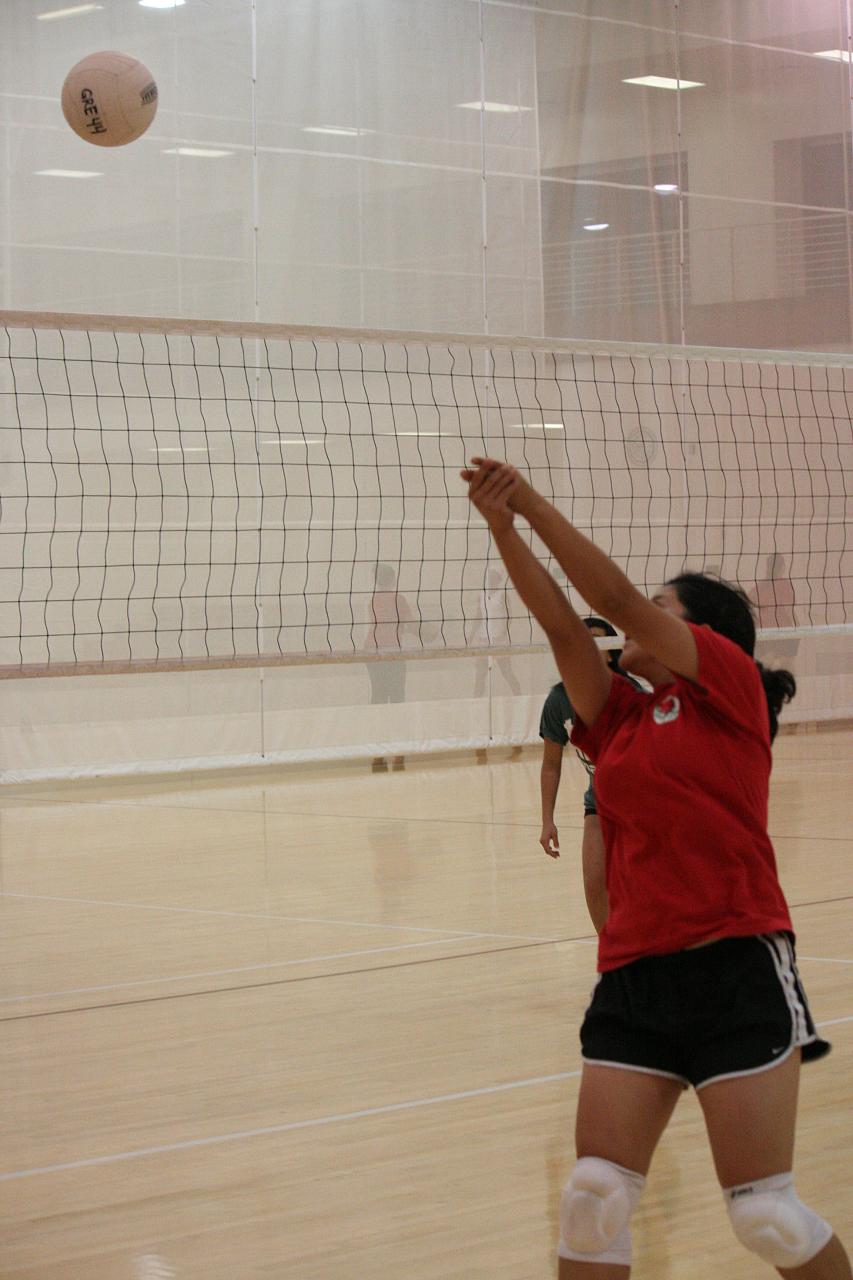 a woman gets ready to hit the volleyball