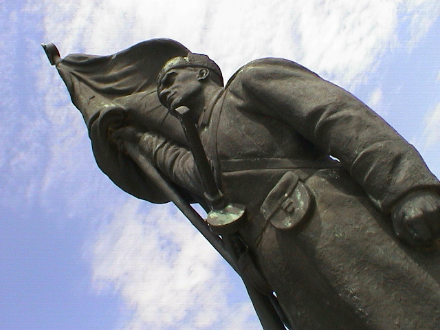a statue of a man is shown with a sky in the background