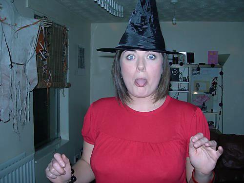 a person wearing a witch hat in a living room