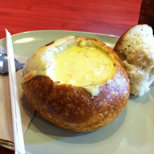 a piece of bread and cheese covered pot pies on a plate