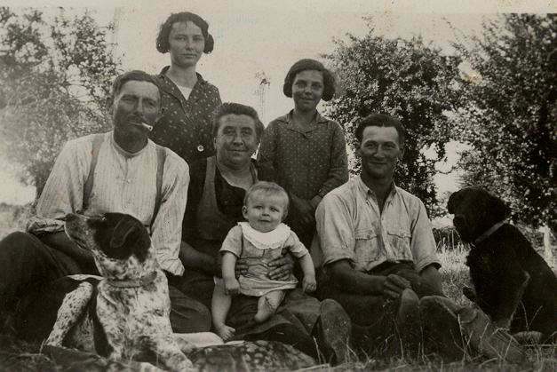 an old picture of a family that is outdoors