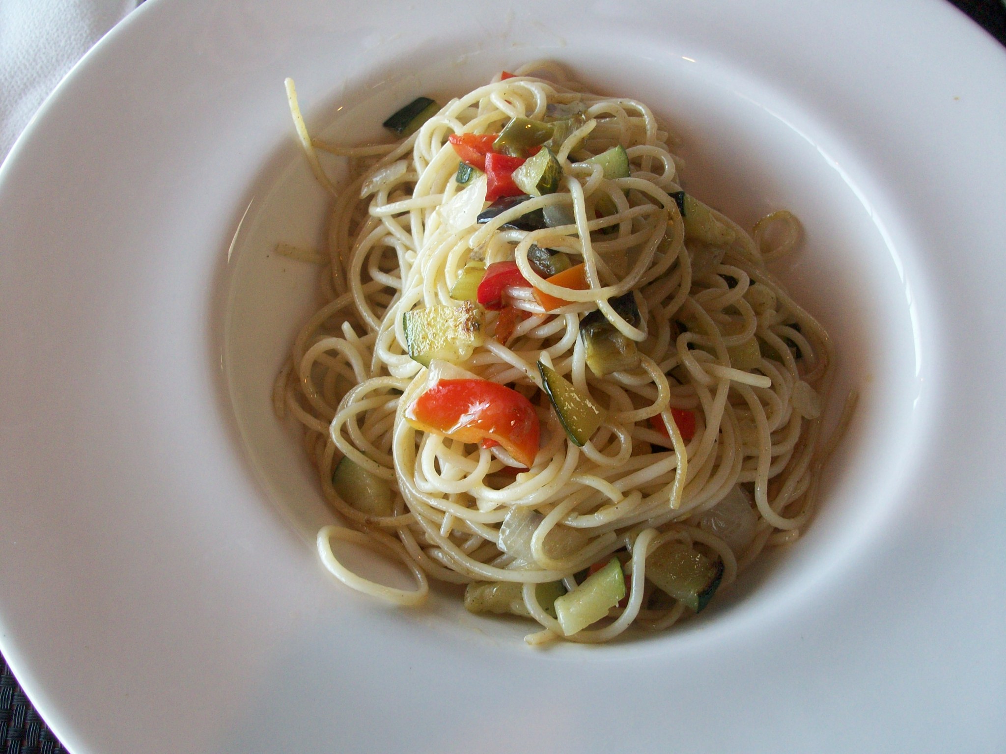 a white plate topped with pasta and vegetables