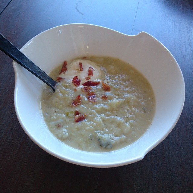 bowl of soup with a spoon in it on a table