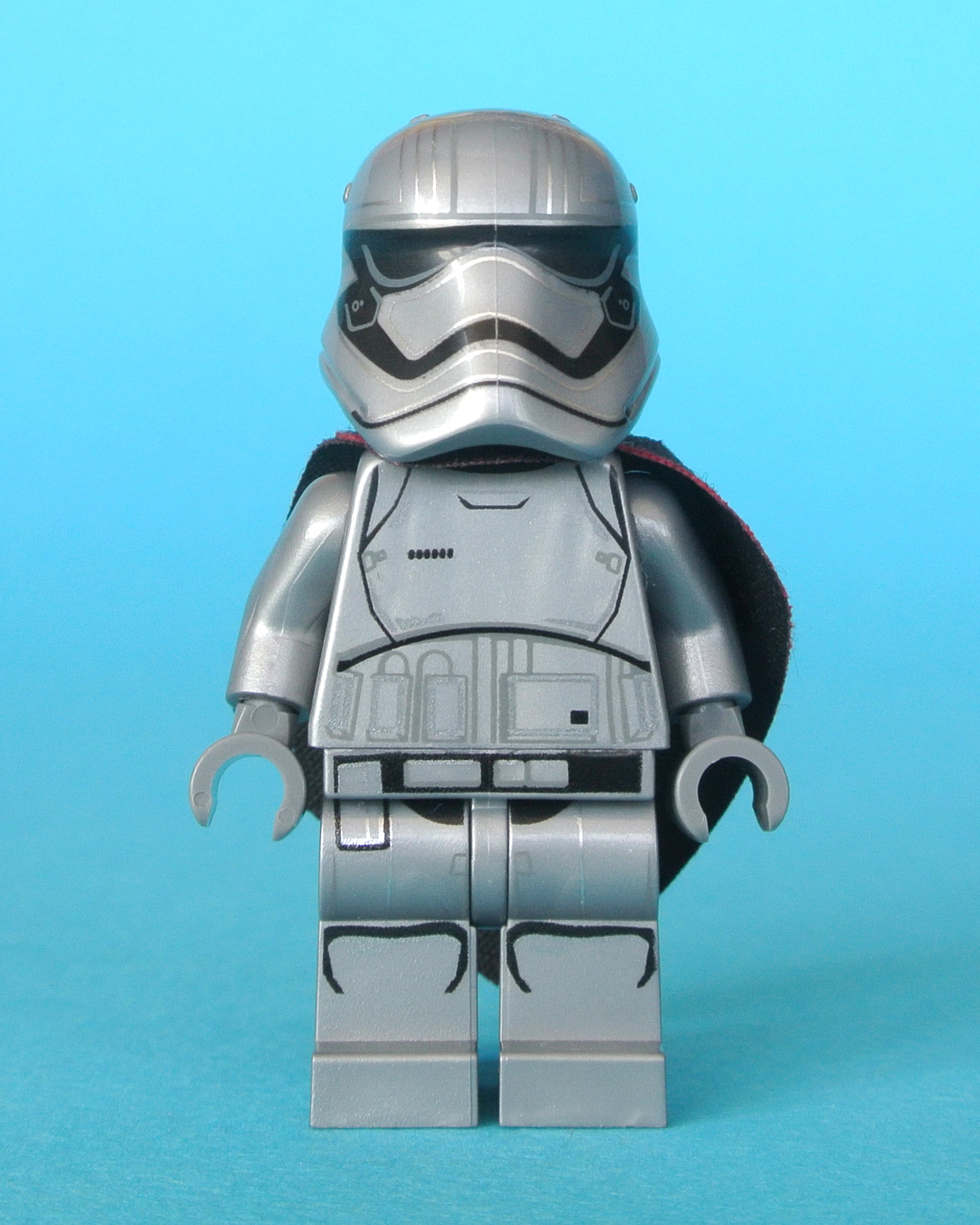 a toy lego boba fett helmet and gray suit