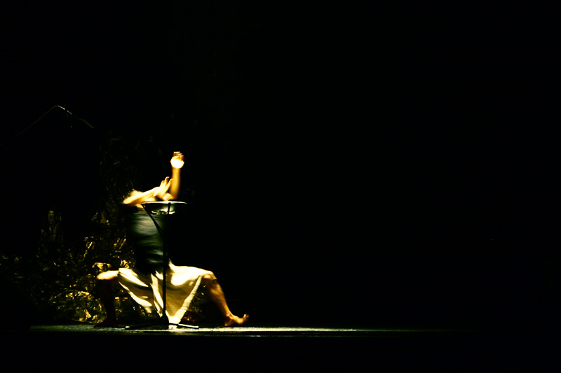 two people on stage playing with a lamp