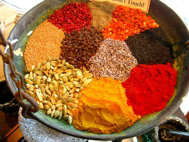 an assortment of spices in a bowl with a sign