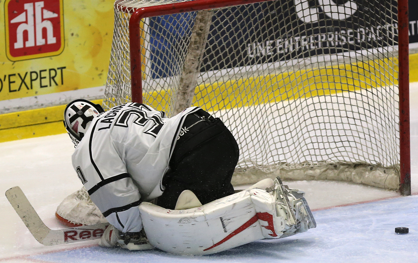 a goalie has caught his back by the net