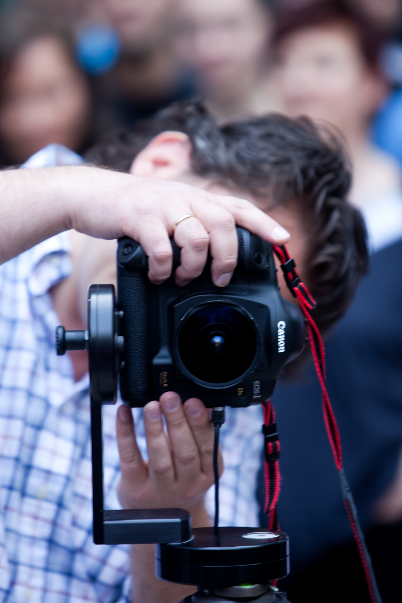 a camera with a hand that is holding a small object