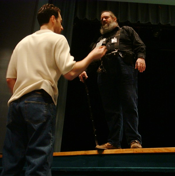 a man with a beard is being shown by a man standing up