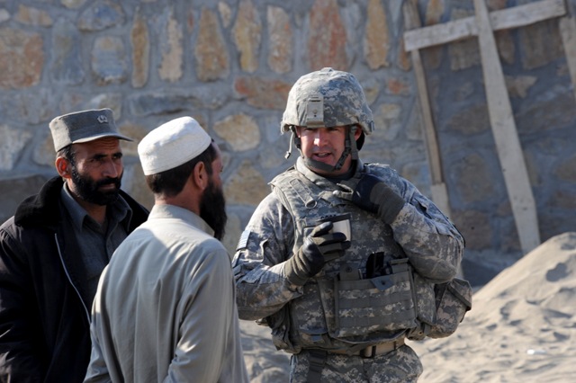 two men talking to two other soldiers