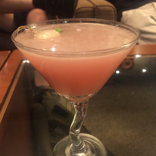 a close up of a glass on a table with a drink