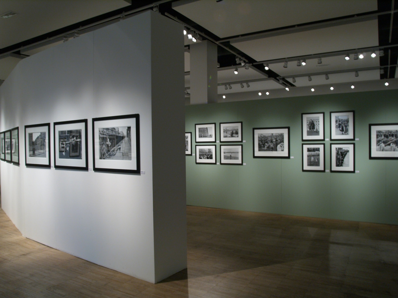 an empty room with some framed pos hanging on the walls