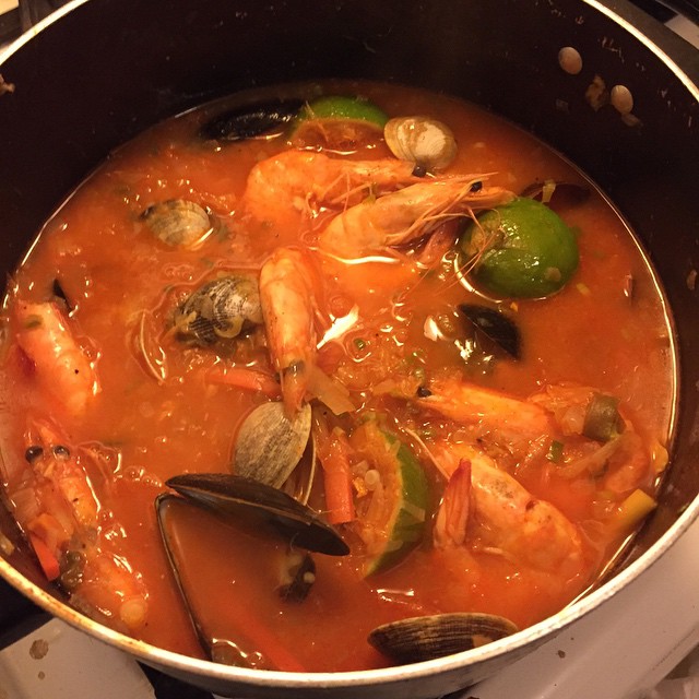 the seafood in the stew is prepared on the stove