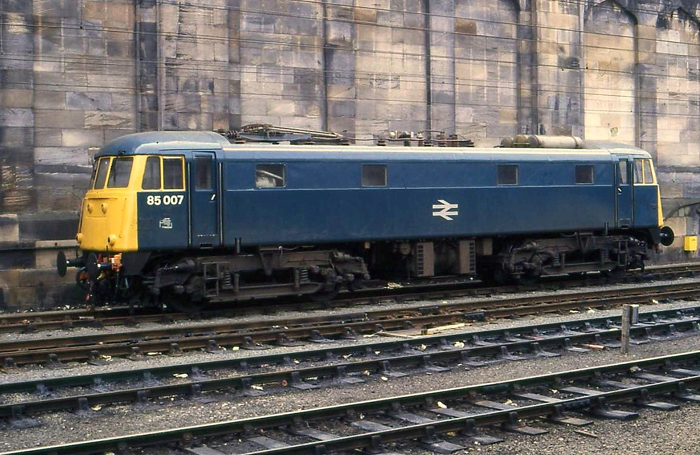 an old passenger train with yellow and blue cars