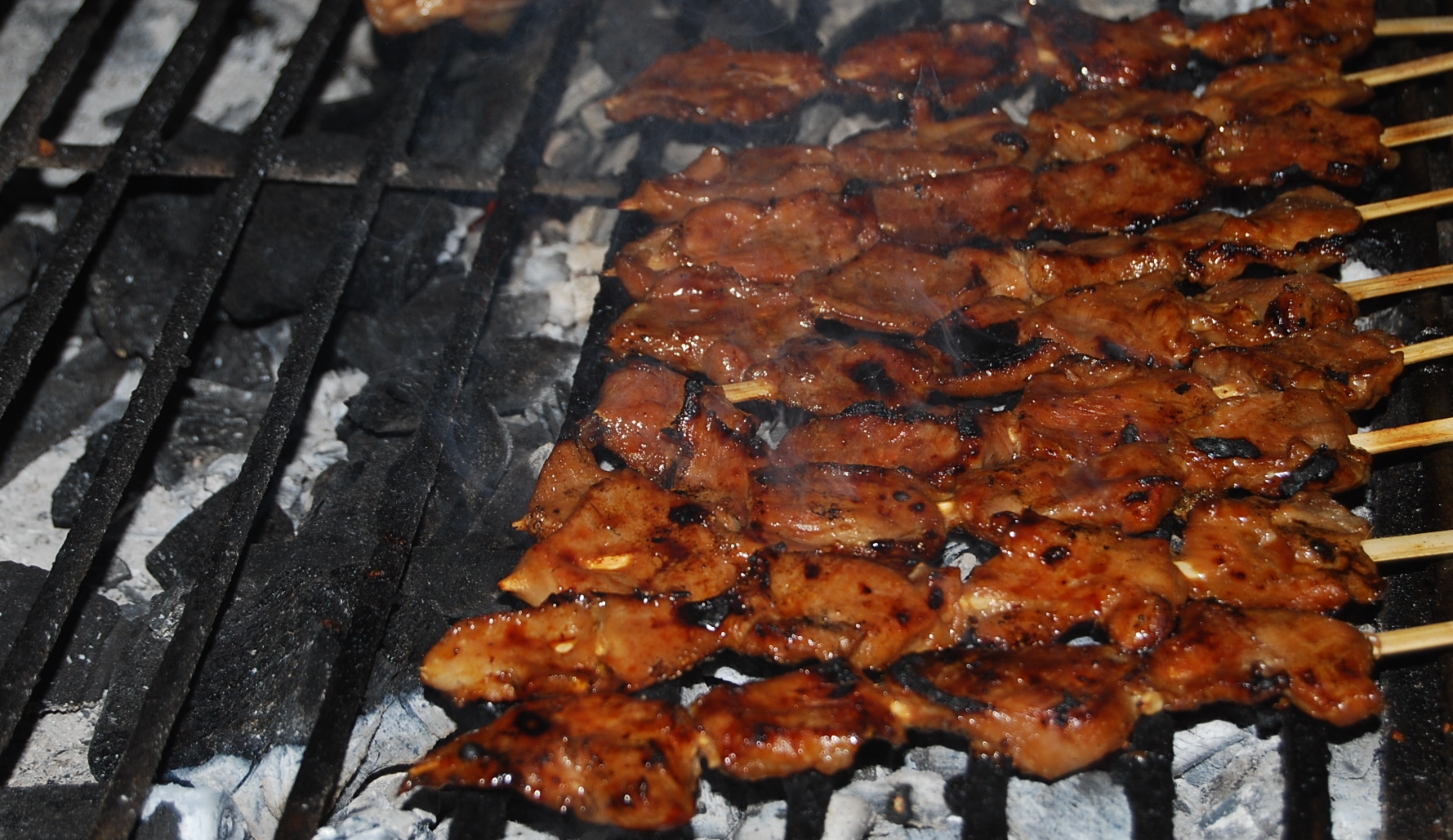 a bunch of food on a stick with skewers