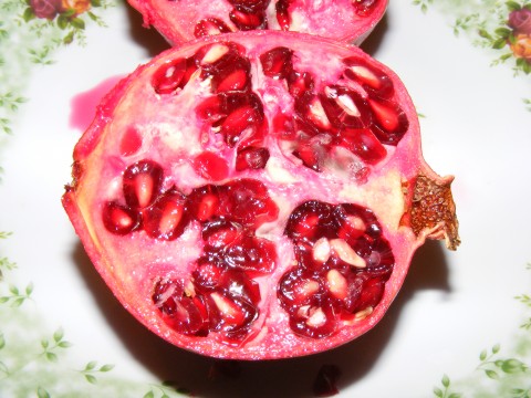 the pomegranate is cut in half on the plate