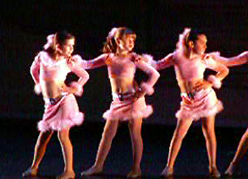 a group of young ladies wearing pink costumes