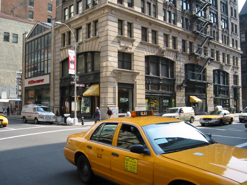a yellow taxi cab is on the street